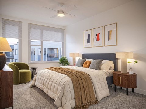 A bedroom with a large bed and a ceiling fan.